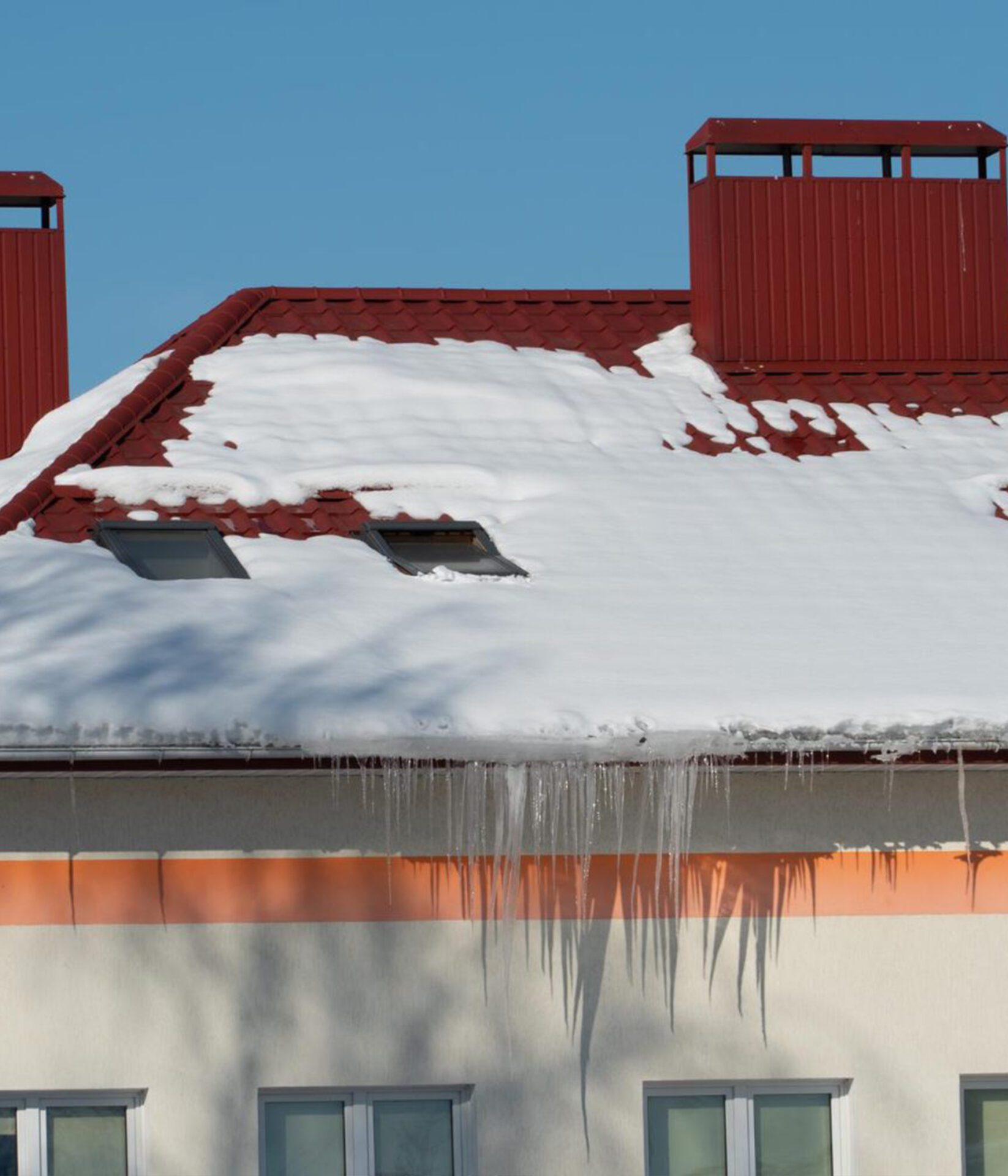 roofs-buildings-are-covered-with-snow-ice-after-big-snowfall-huge-icicles-hang-from-facades-buildings-fall-icicles-carries-danger-people-s-lives-image-scaled